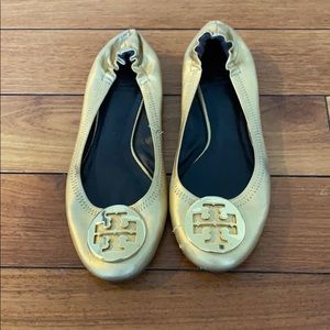 Tory Burch gold slip on‘s